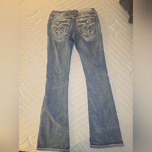 Rock Revival Women's Distressed Blue Jeans with Embellished Pockets